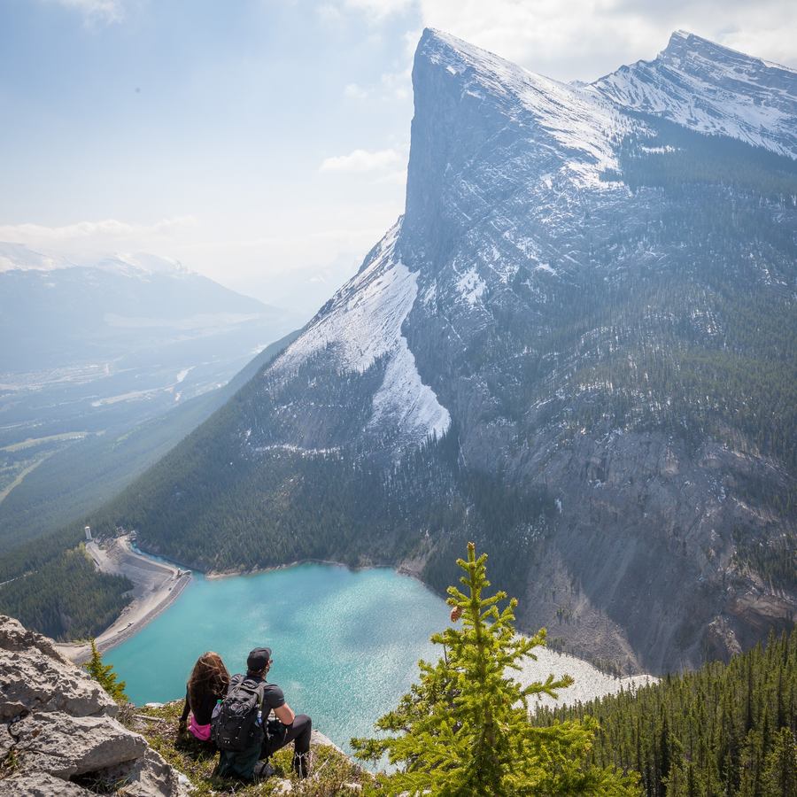 Couple on mountainside looking up to the peak