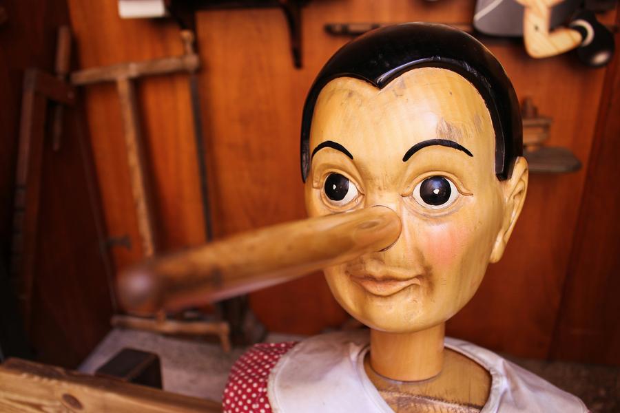 a wooden dall with a long nose