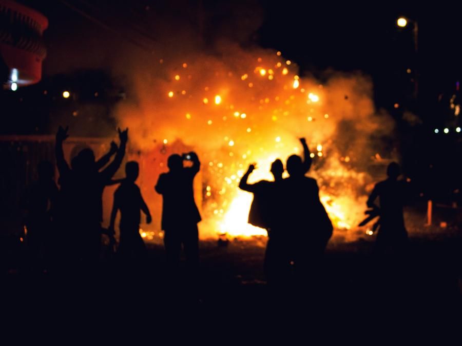 rioters and fire, at night, outdoors