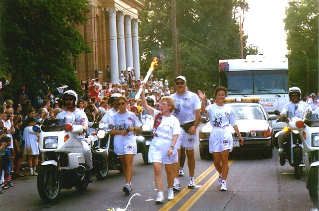 deenie mckeever, carrying 1996 olympic torch in cartersville georgia
