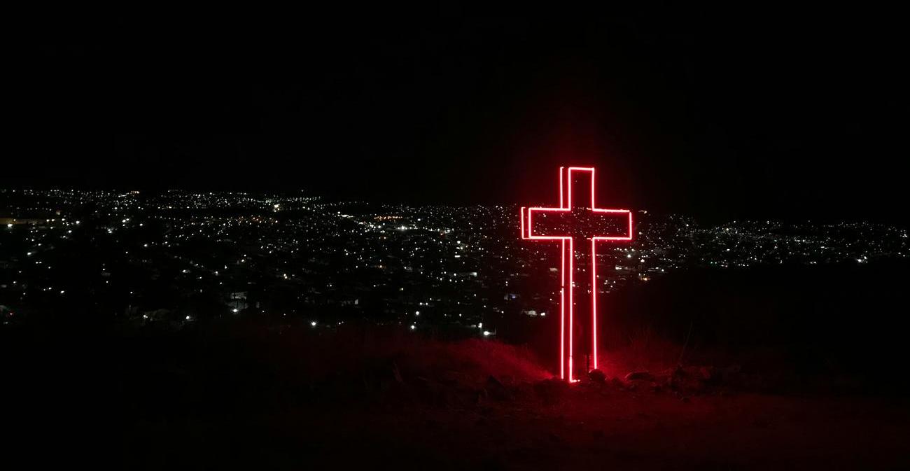 a cross in the city at night
