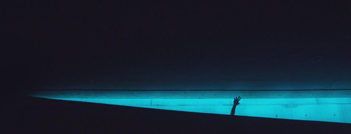 nightime, poolside, hand in the air