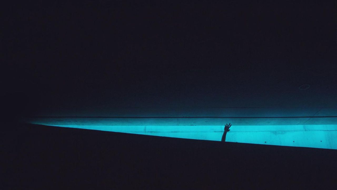 nightime, poolside, hand in the air