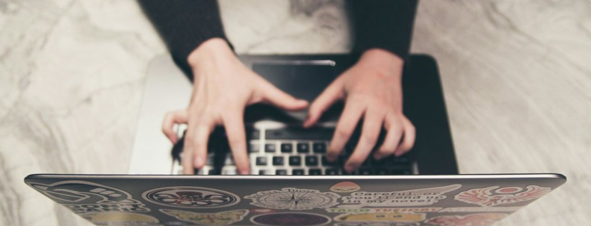 woman typing on a computer on a desk indoors