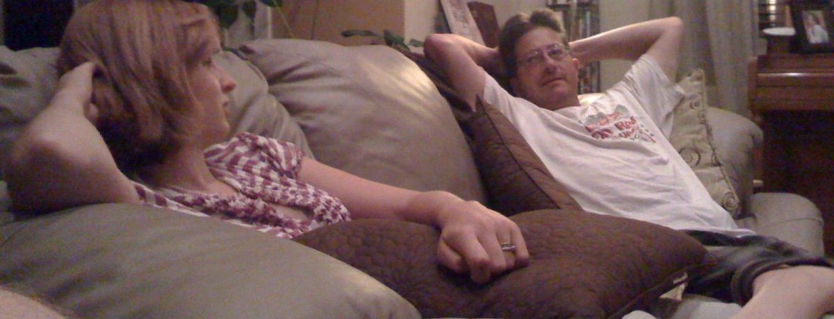 cait and steve montoya talking on the couch