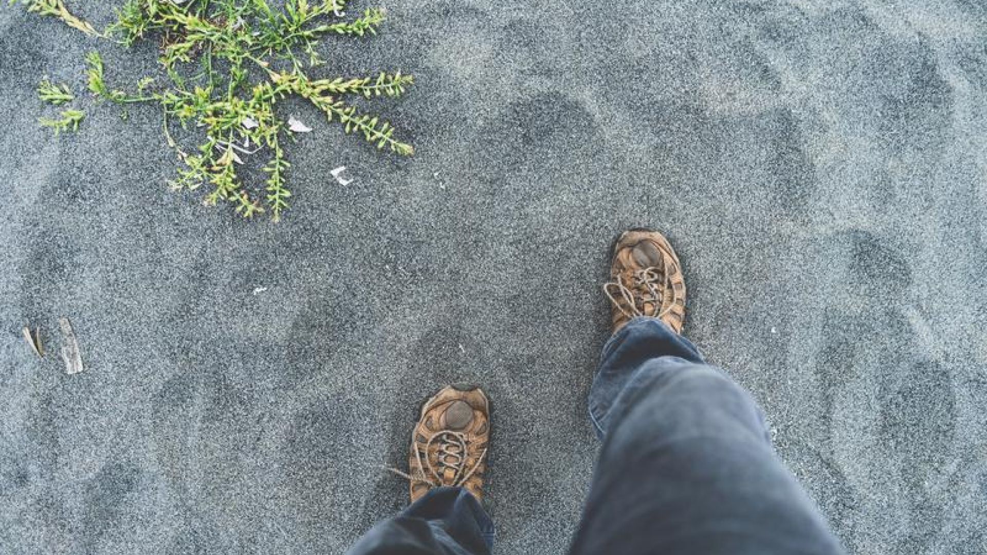 Steps onto sand, feet view