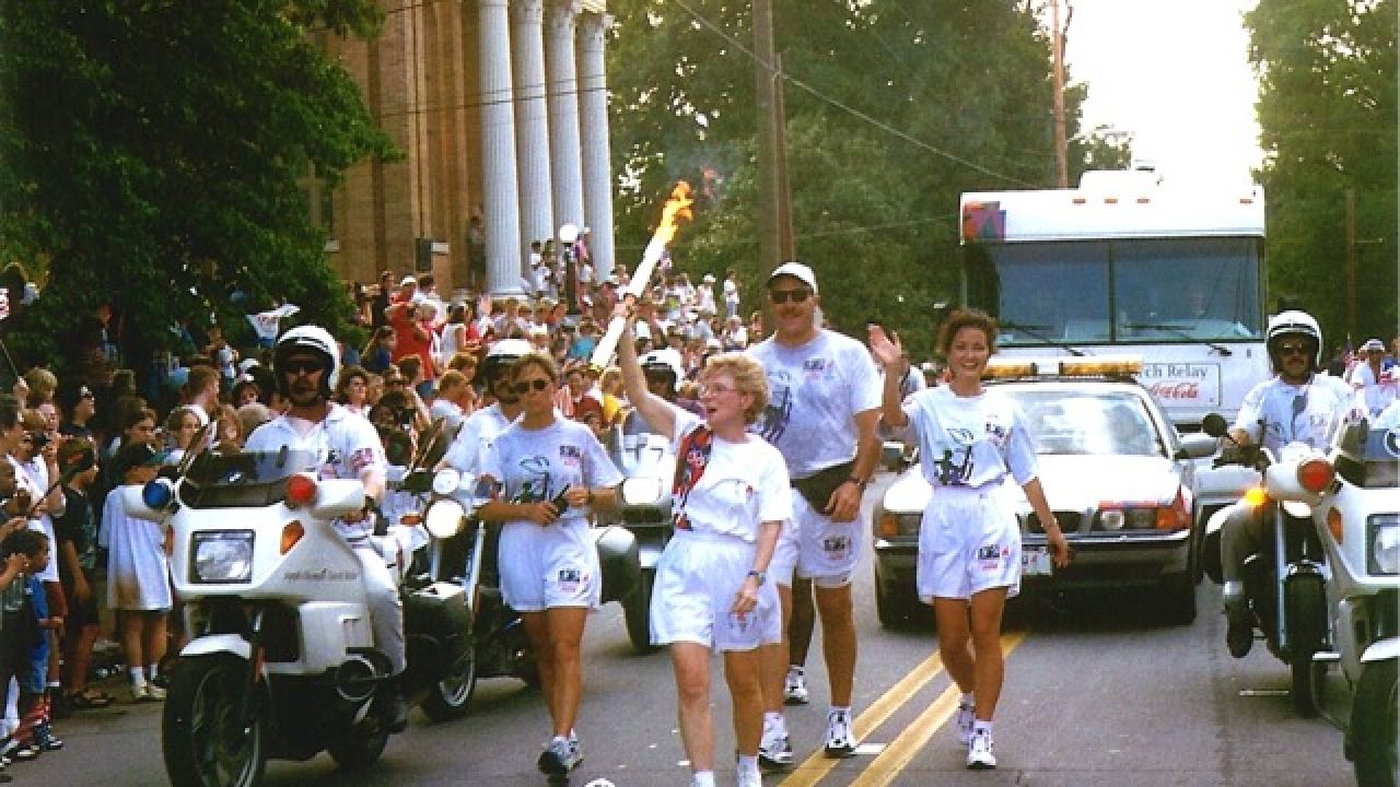 deenie mckeever, carrying 1996 olympic torch in cartersville georgia