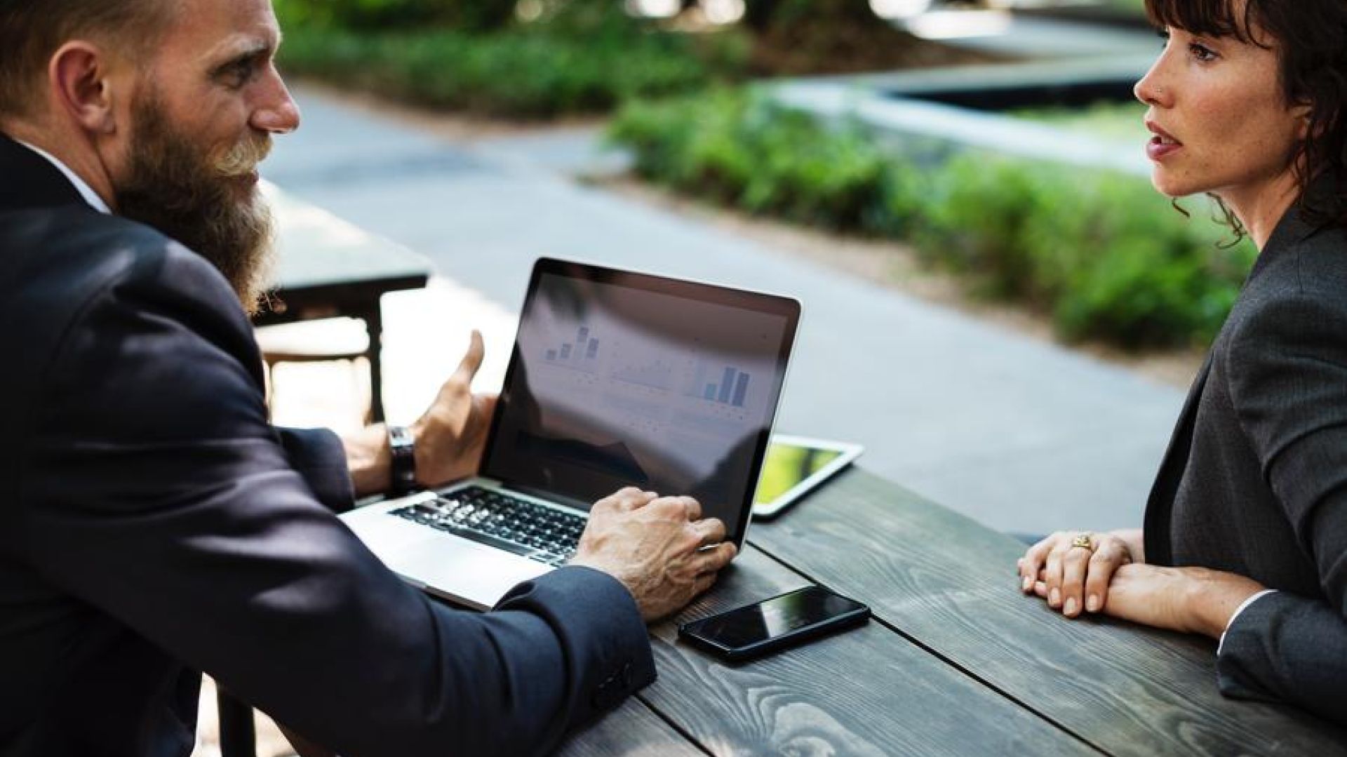 A Man & Woman Talking With A Computer