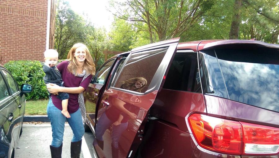 Cait Montoya with Kia Sedona Van and child