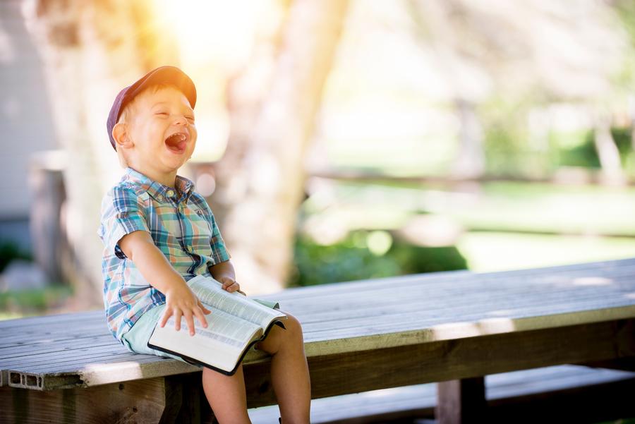 Laughing Child Reading The Bible