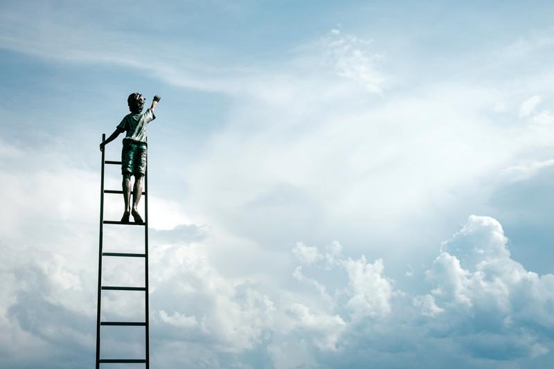 kid reaching out to the sky