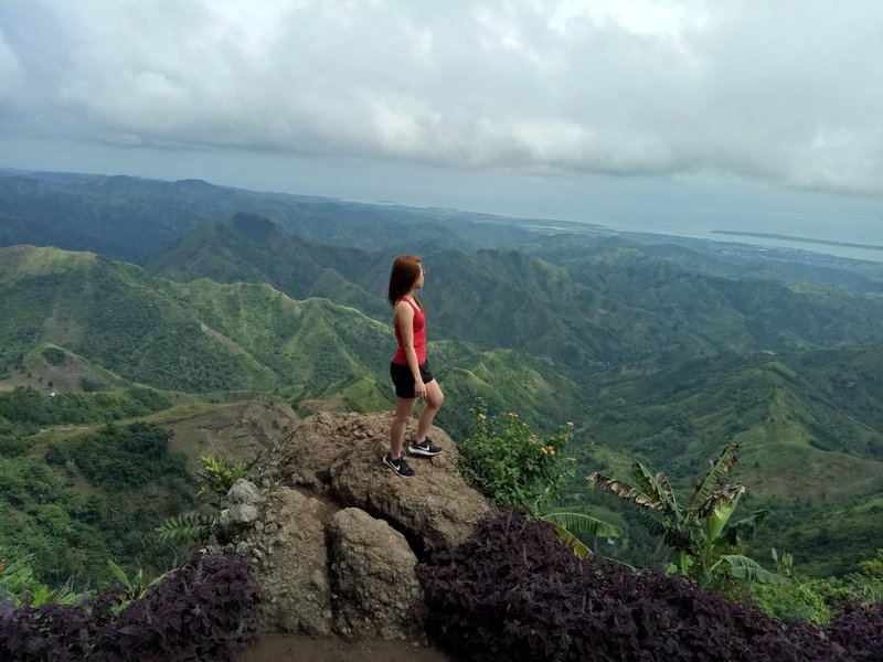 Woman standing on mountain looking out