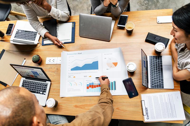 Business report gathering around table to review