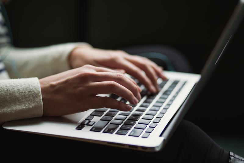hands typing on a computer