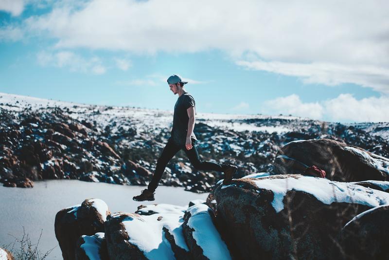 Young man stepping on the cliff's edge