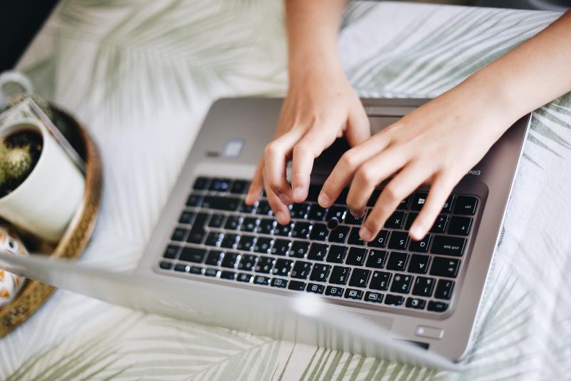typing on a computer on a table