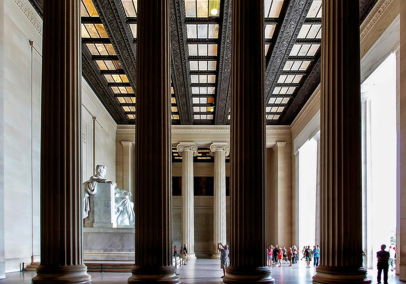 4 pillars of a building with people around