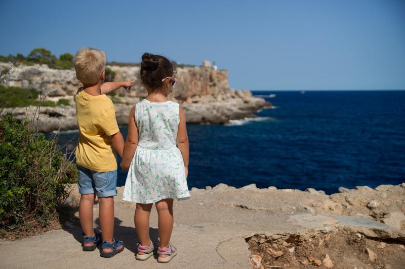 boy leading a girl, pointing out to the horizon
