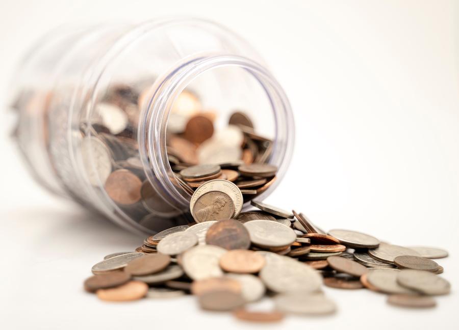 coin money spilling out of a jar