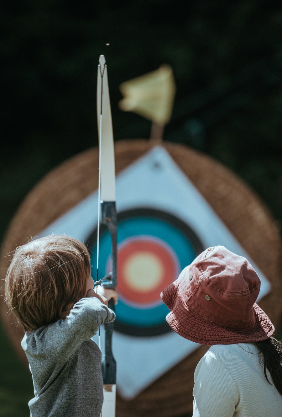 kid shooting arrow at target