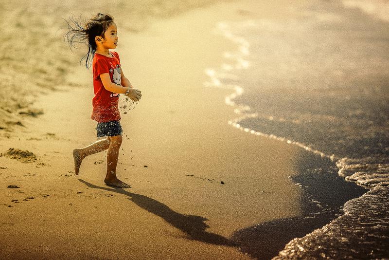 Kid at beach, near water