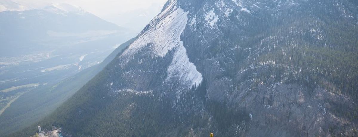 Couple on mountainside looking up to the peak