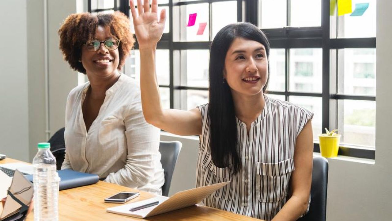 woman raising her hand