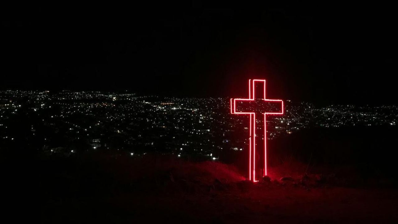 a cross in the city at night