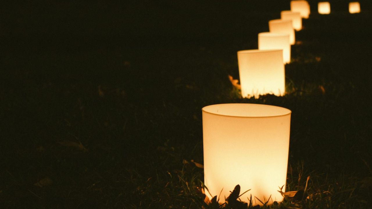 string of candles on the ground at night