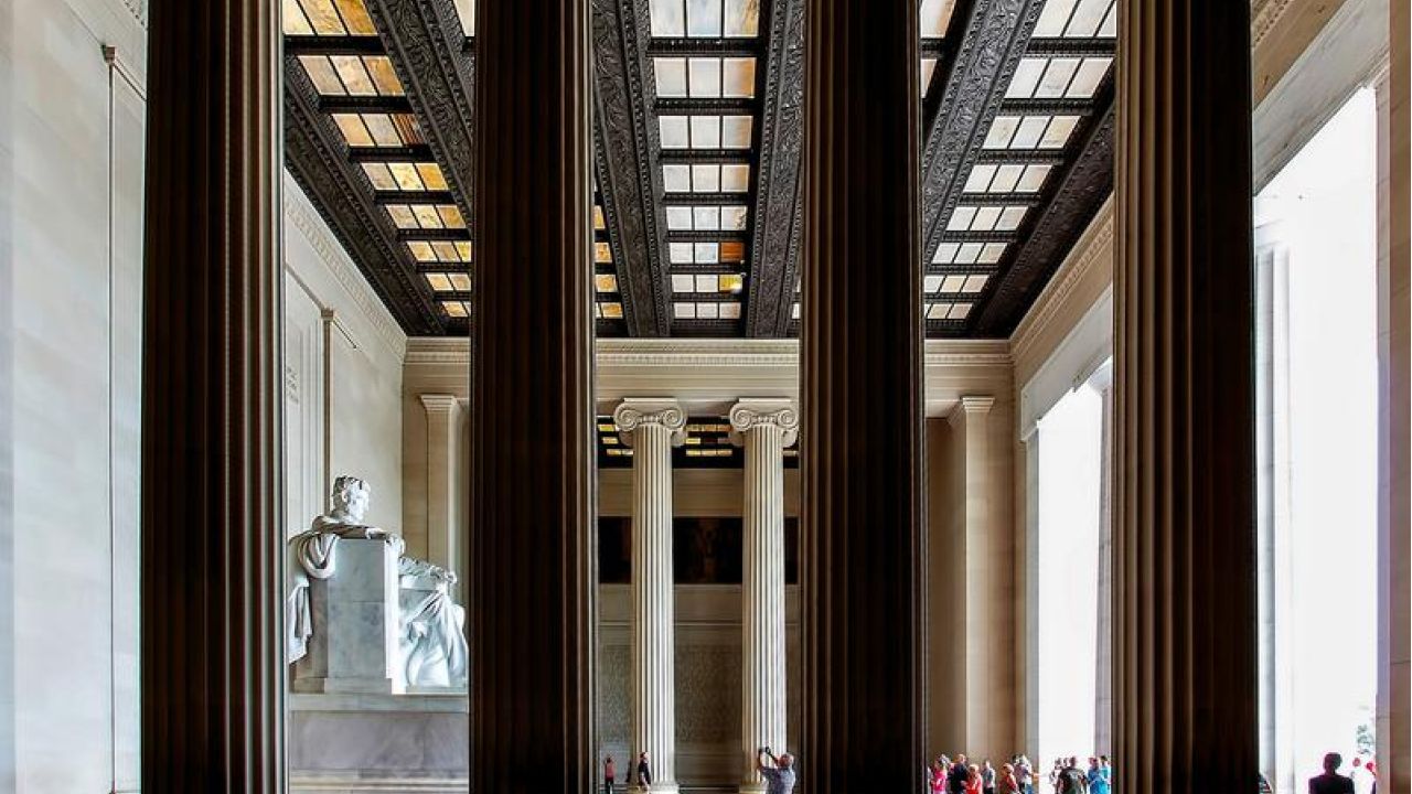 4 pillars of a building with people around