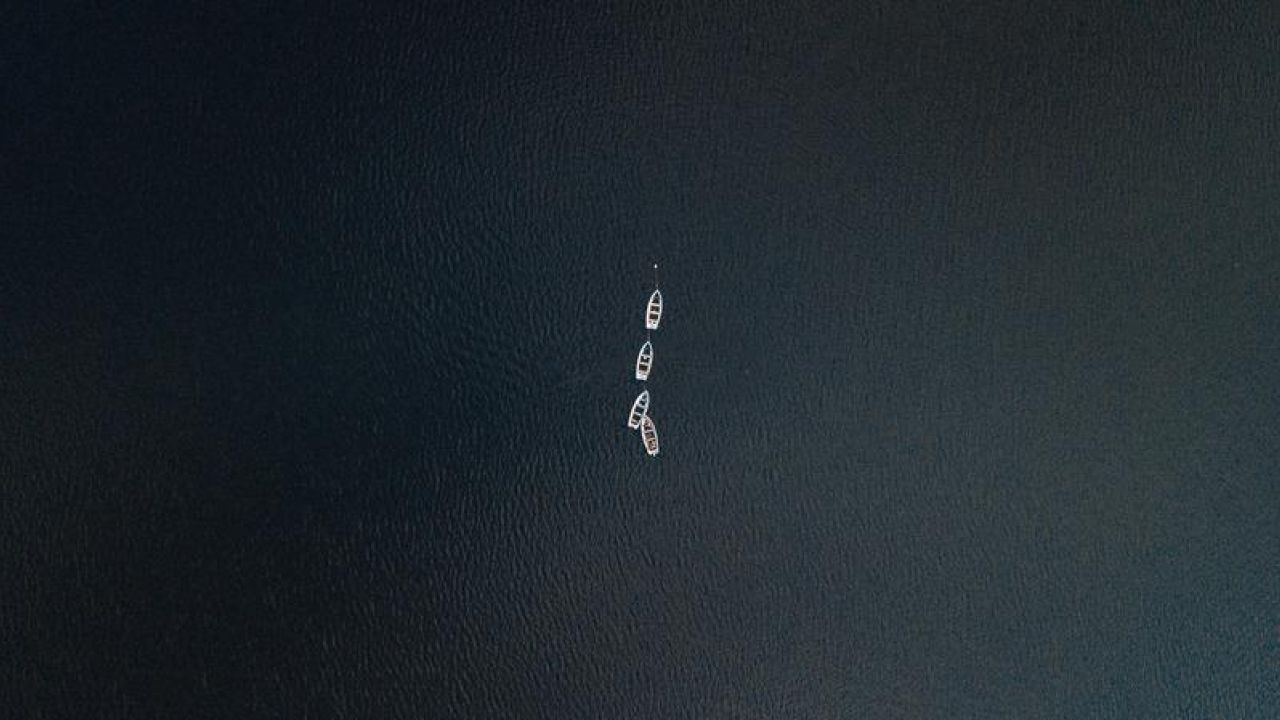 boats in the middle of a large ocean