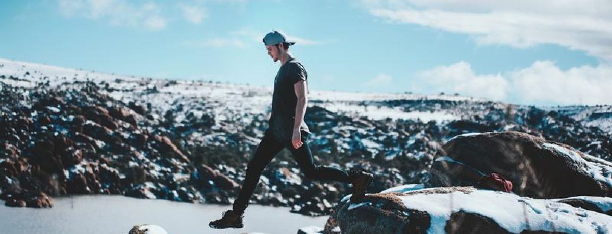 Young man stepping on the cliff's edge