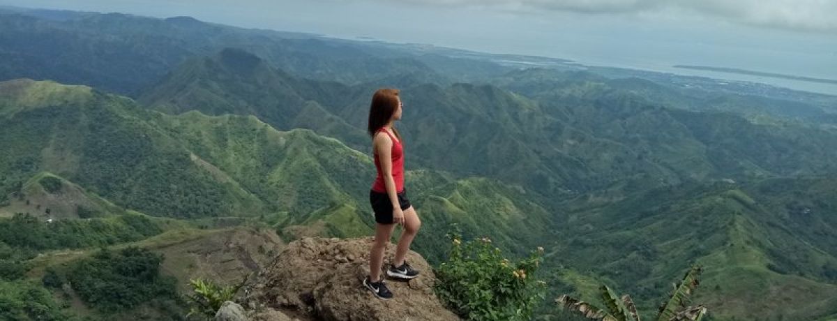 Woman standing on mountain looking out