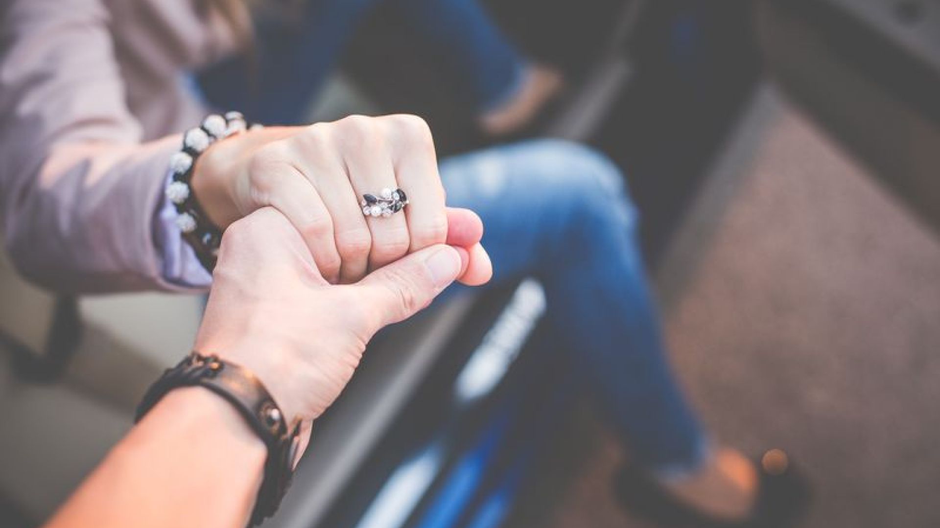 a man helping a lady out of a car