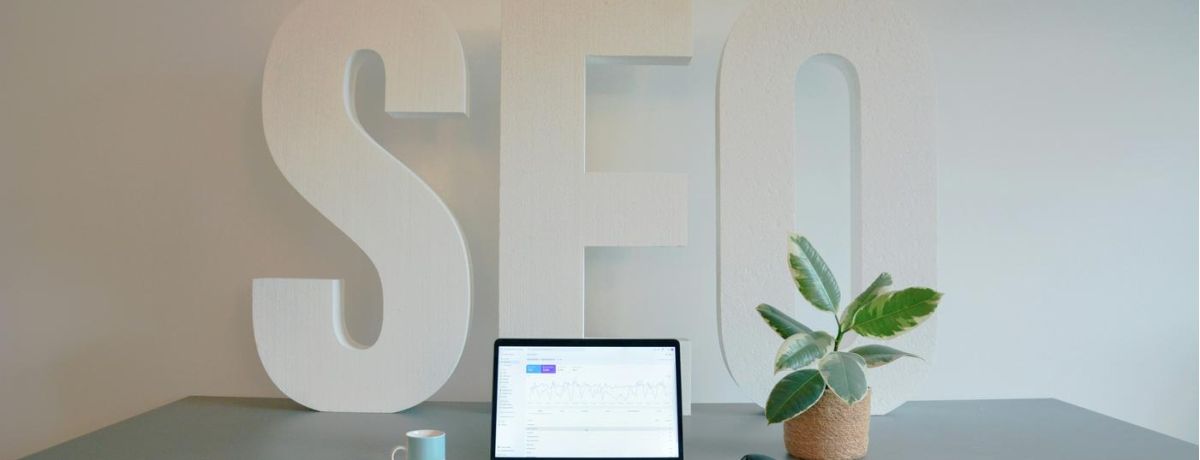 seo agency sign, marketing firm table with laptop and plant