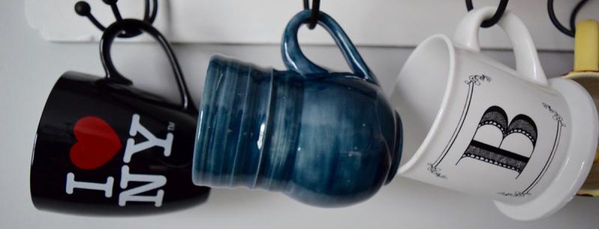 several mugs hanging on the rack