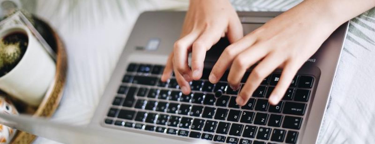 typing on a computer on a table