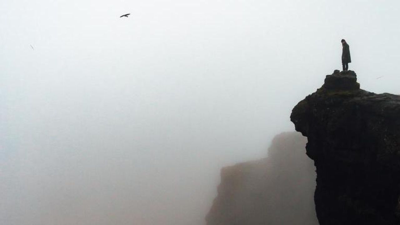 looking out to the horizon over a foggy cliff