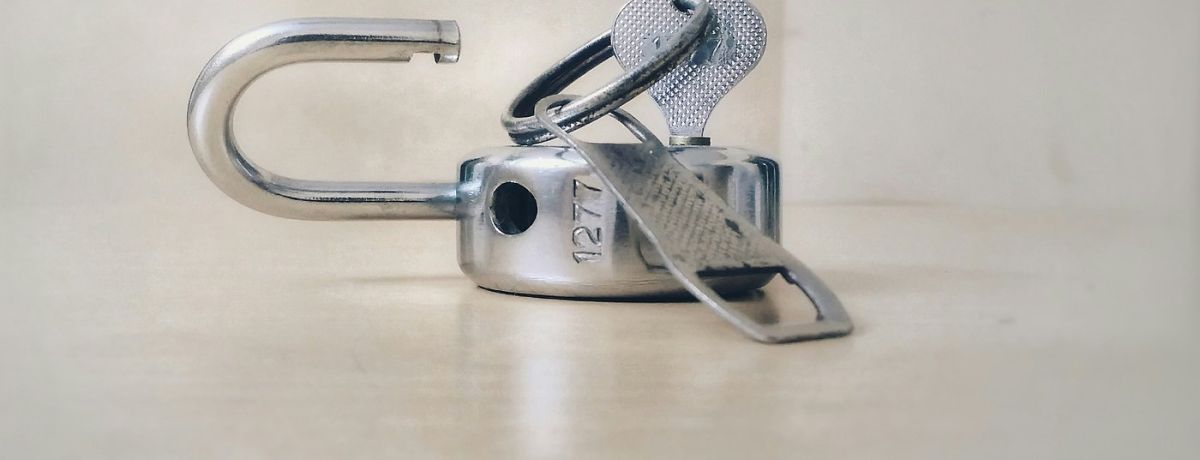 key unlocking a lock, on floor indoors