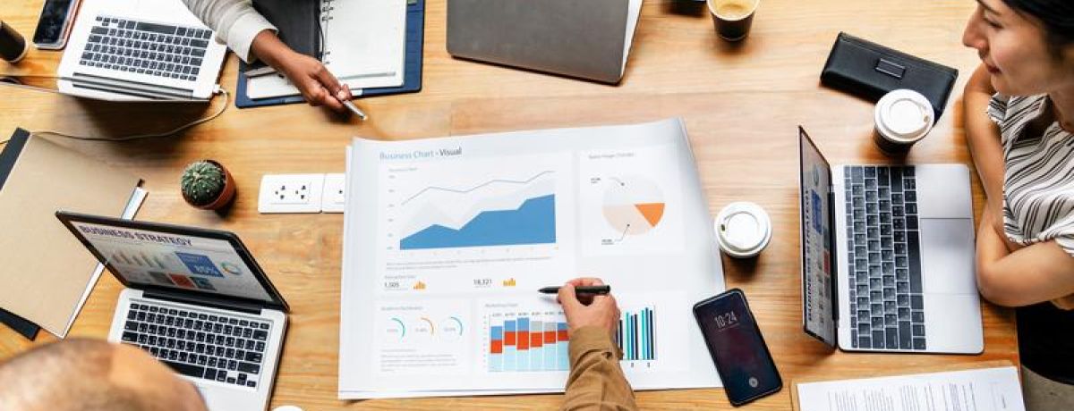 Business report gathering around table to review