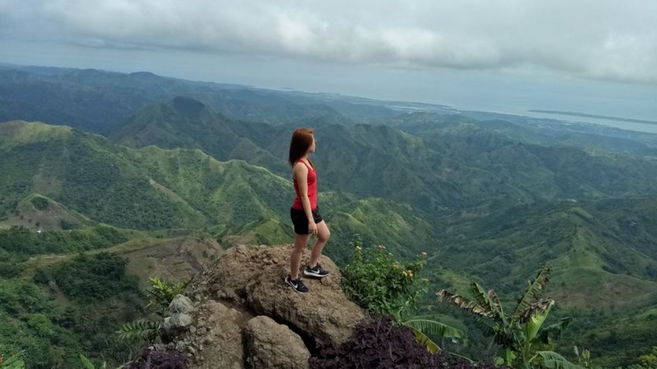 Woman standing on mountain looking out