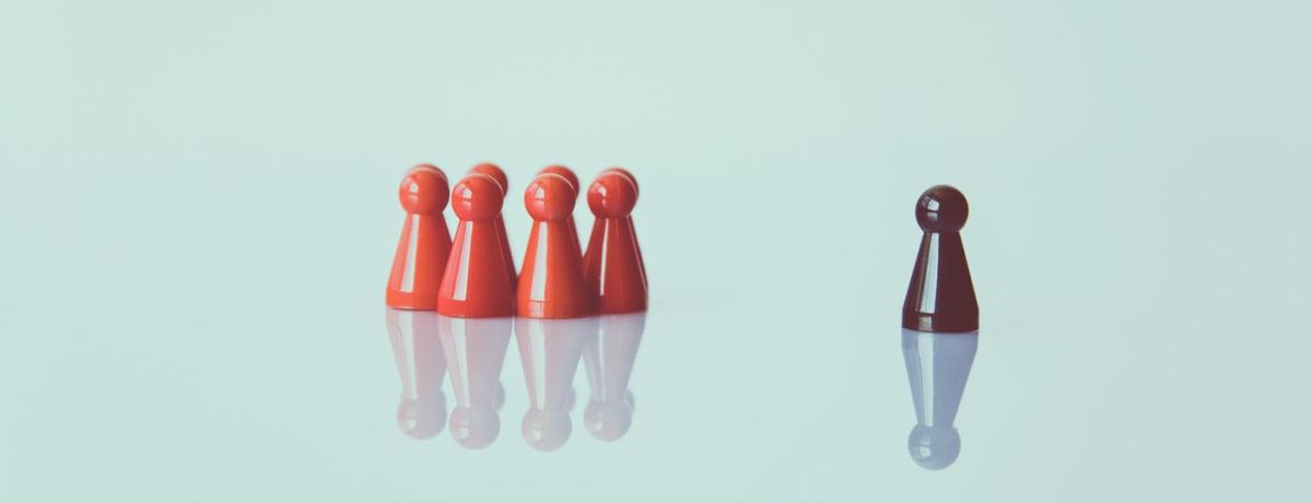 photo of a game pawns on a glass table with a red standout