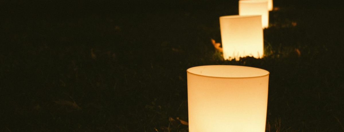 string of candles on the ground at night
