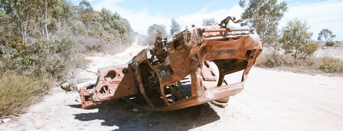upside down car, destroyed on sand