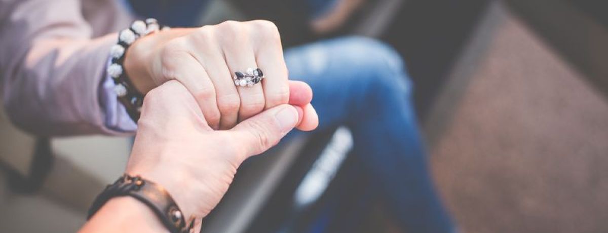 a man helping a lady out of a car
