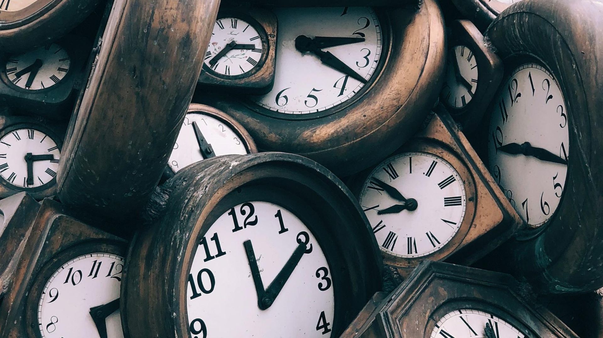 a bunch of clocks in a pile