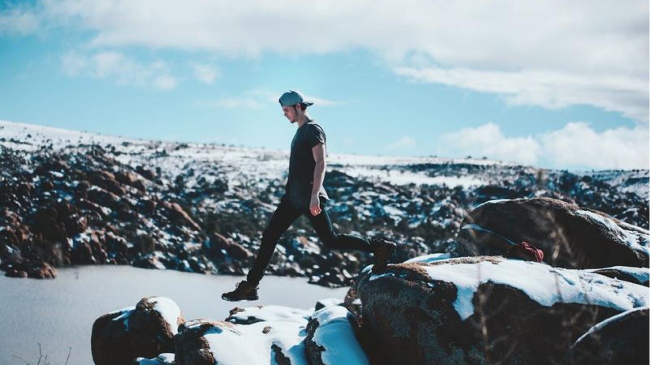 Young man stepping on the cliff's edge
