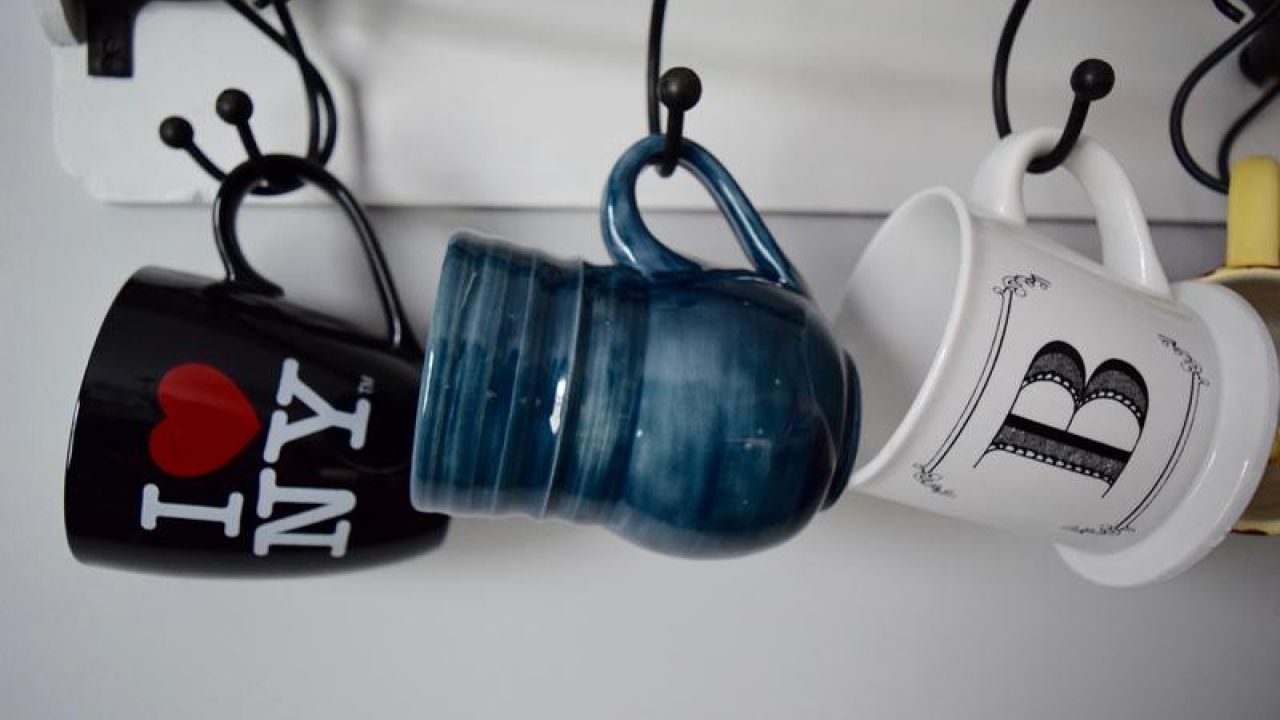 several mugs hanging on the rack