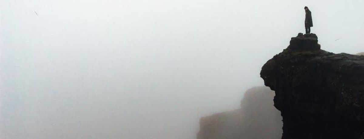 looking out to the horizon over a foggy cliff