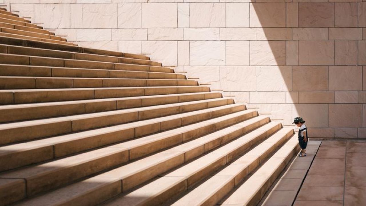 kid looking up stairs about to start climbing